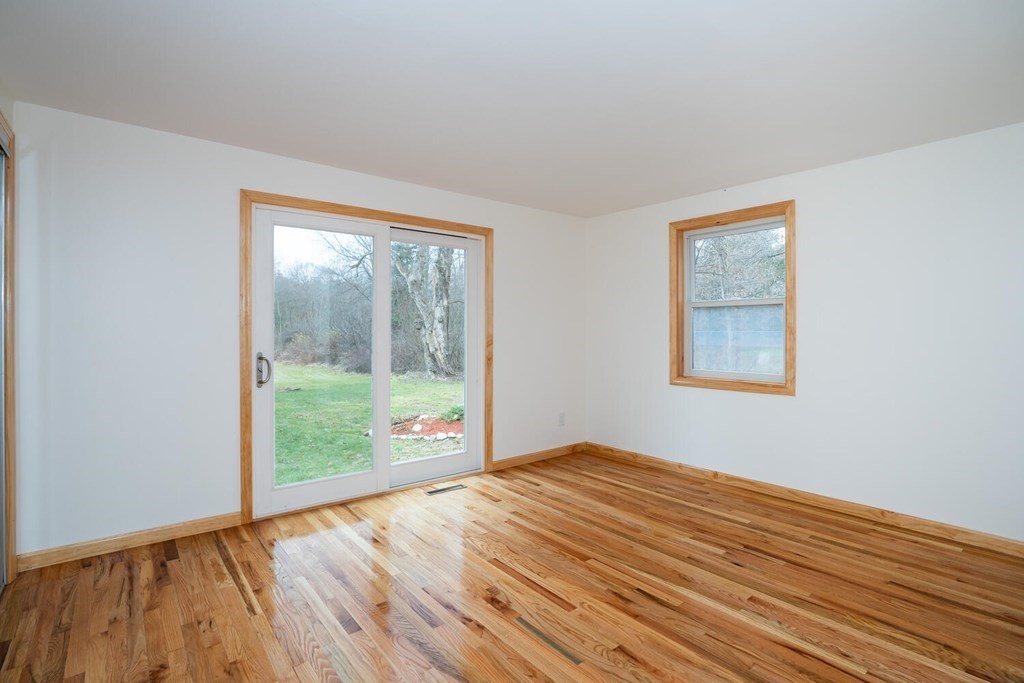 70 Leverett Road Amherst, MA 01002 - Photo 30 of 42 a view of an empty room with wooden floor and a window