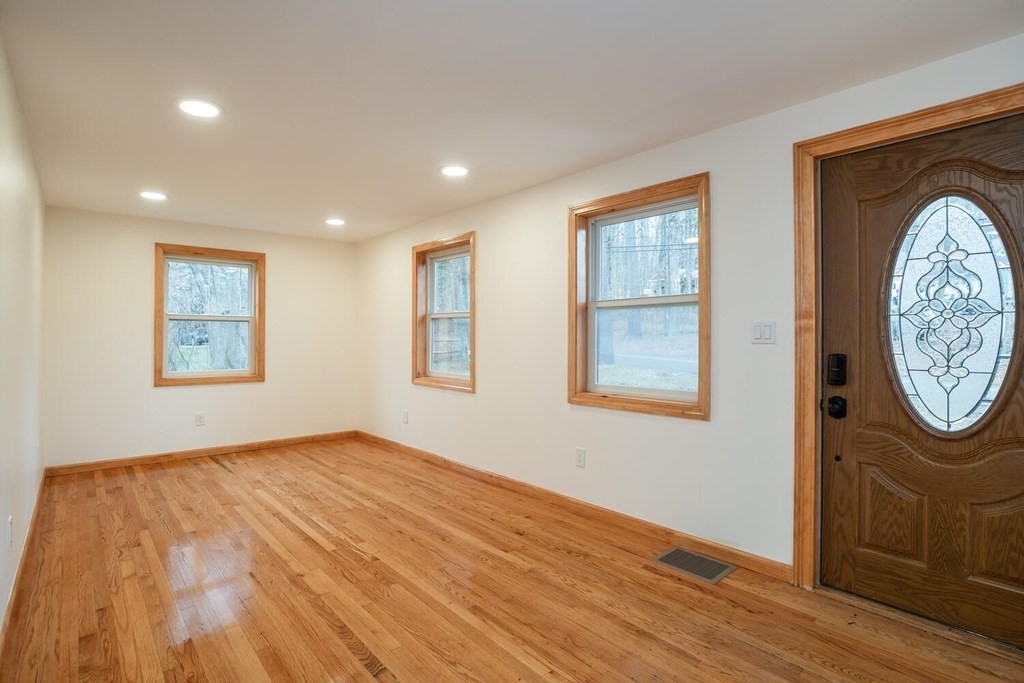70 Leverett Road Amherst, MA 01002 - Photo 5 of 42 a view of an empty room with wooden floor and a window