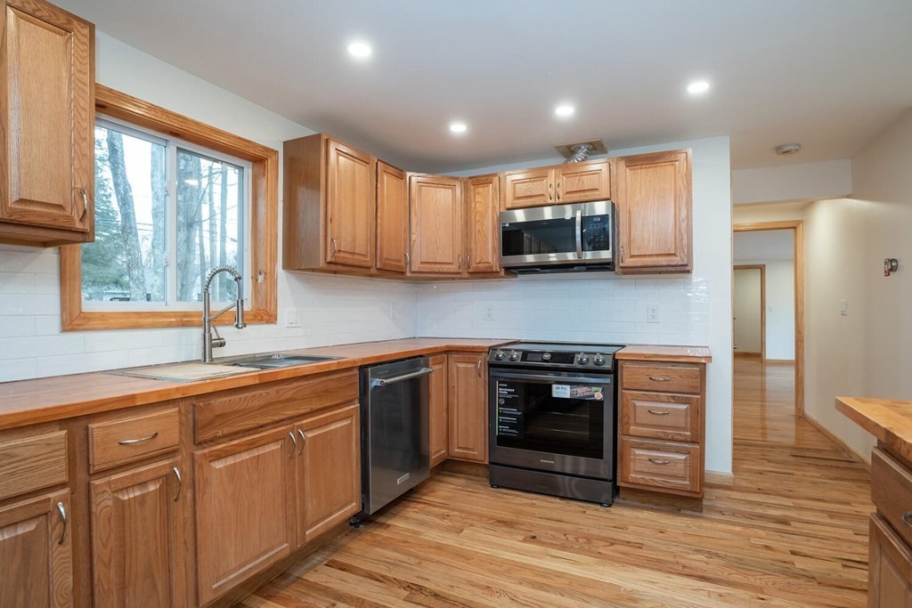 70 Leverett Road Amherst, MA 01002 - Photo 7 of 42 a kitchen with stainless steel appliances granite countertop a stove sink and cabinets