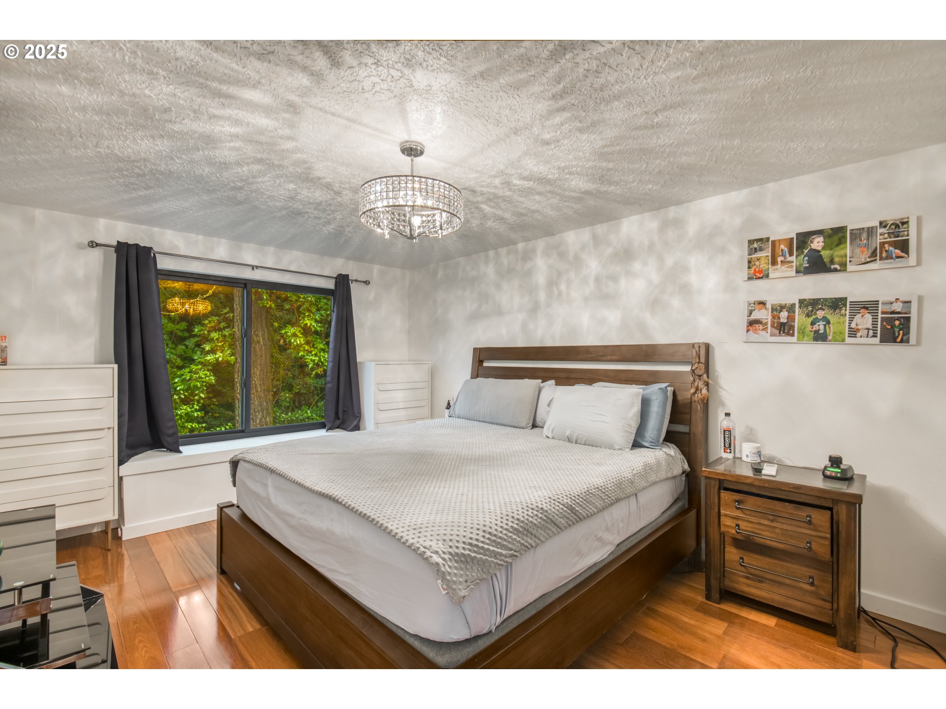 6196 Southwest Capitol Highway Portland, OR 97239 - Photo 11 of 18 a bedroom with a bed and a dresser next to a window