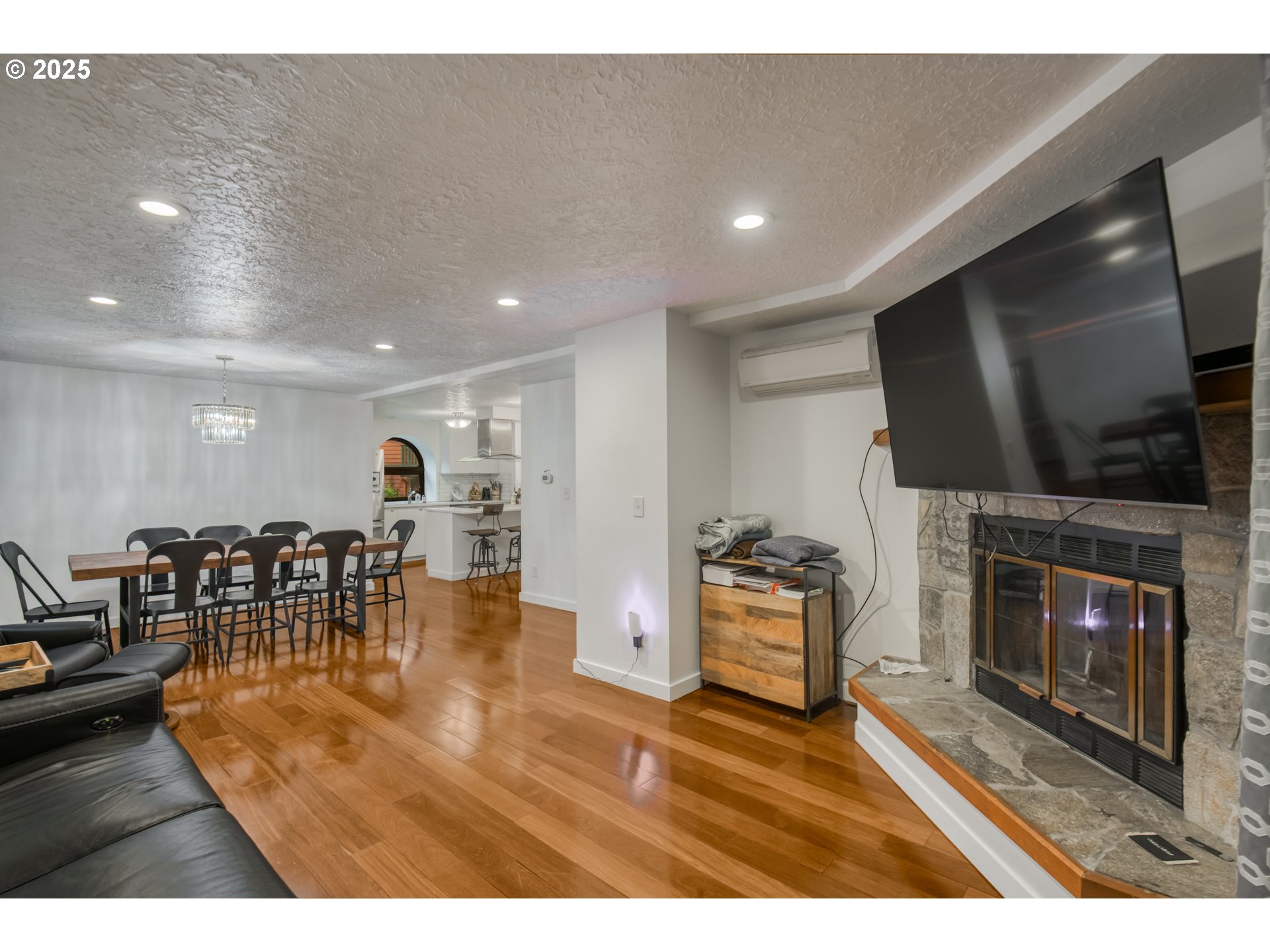 6196 Southwest Capitol Highway Portland, OR 97239 - Photo 4 of 18 a living room with fireplace furniture and a flat screen tv