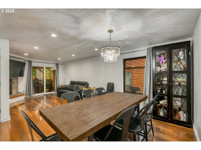 a view of a dining room with furniture and chandelier