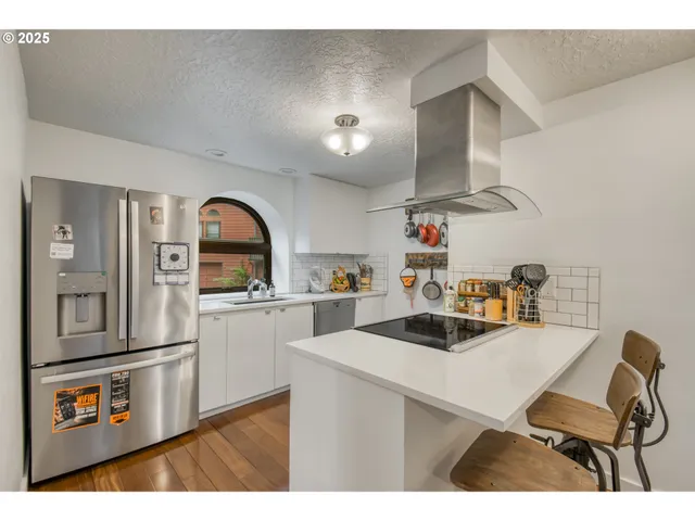 a kitchen with a sink cabinets and appliances