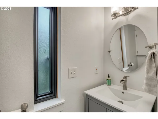 a bathroom with a sink vanity and a mirror
