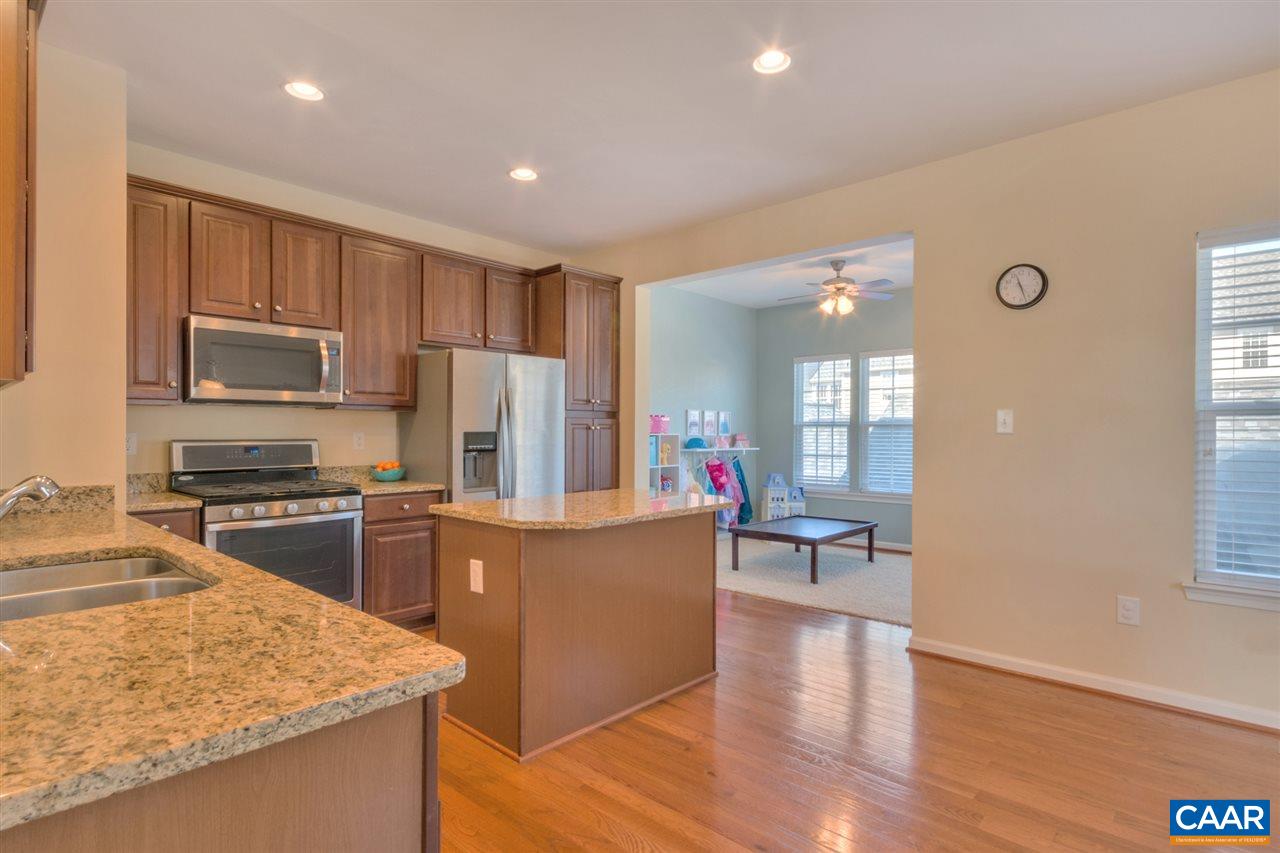 735 Rainier Road Charlottesville, VA 22903 - Photo 14 of 30 a kitchen with kitchen island a counter top space a sink stainless steel appliances and cabinets