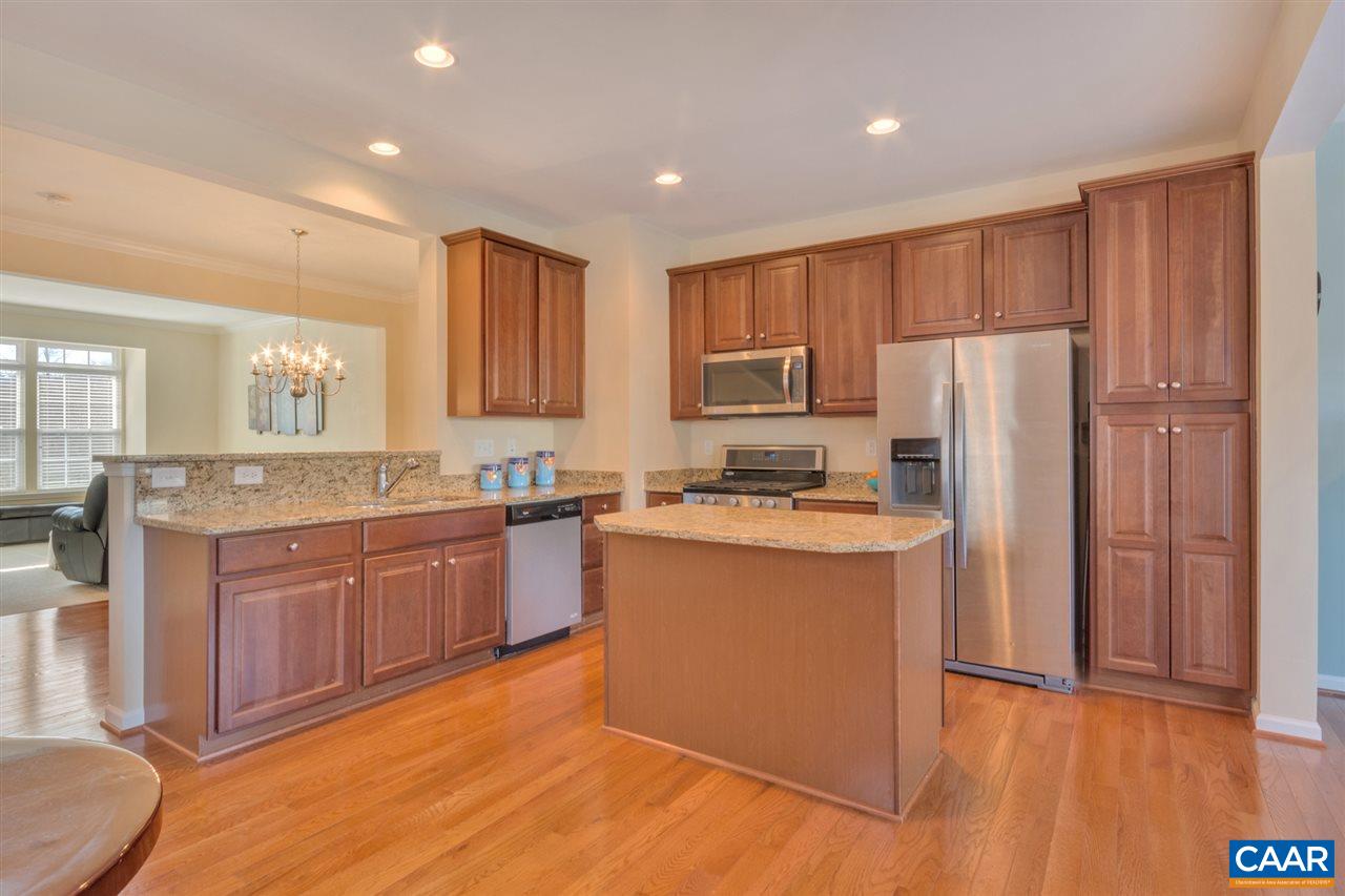 735 Rainier Road Charlottesville, VA 22903 - Photo 15 of 30 a kitchen with stainless steel appliances granite countertop a refrigerator a sink dishwasher and a stove with wooden floor
