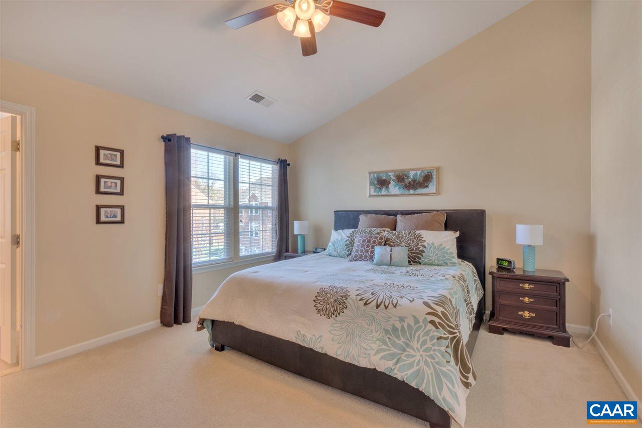 735 Rainier Road Charlottesville, VA 22903 - Photo 21 of 30 a bedroom with a large bed and a chandelier