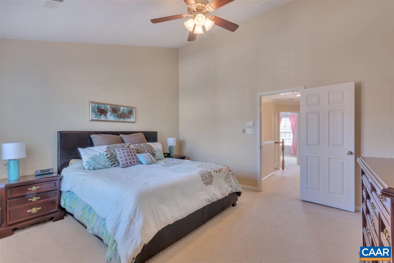 735 Rainier Road Charlottesville, VA 22903 - Photo 22 of 30 a bedroom with a bed and a chandelier