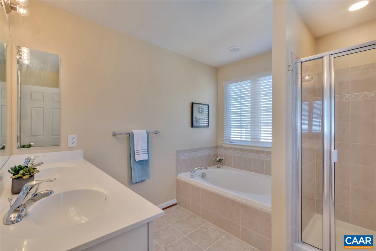 735 Rainier Road Charlottesville, VA 22903 - Photo 23 of 30 a bathroom with a tub sink and mirror