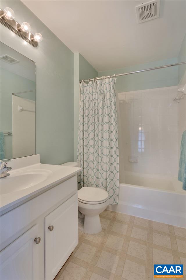 735 Rainier Road Charlottesville, VA 22903 - Photo 28 of 30 a bathroom with a granite countertop sink a toilet a mirror and shower