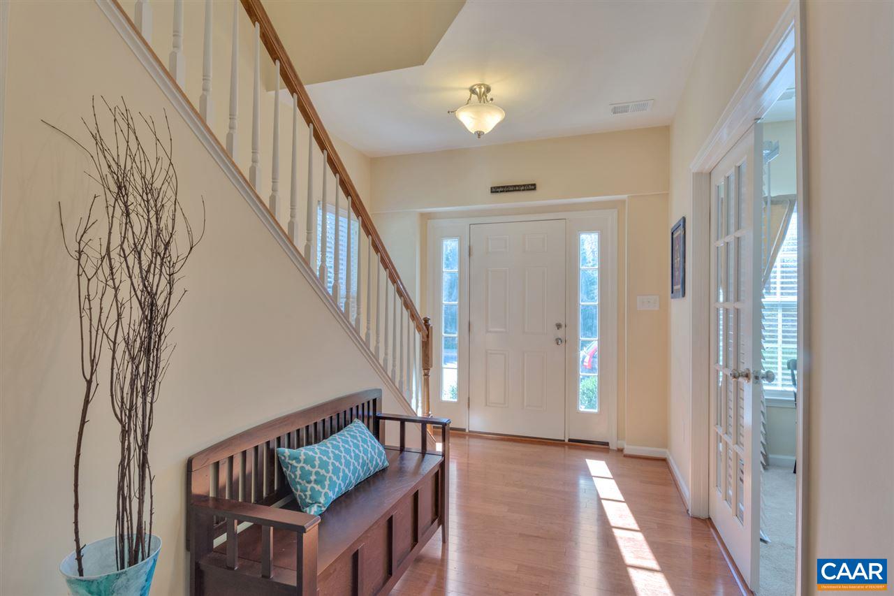 735 Rainier Road Charlottesville, VA 22903 - Photo 3 of 30 a view of stairs and an entryway with wooden floor