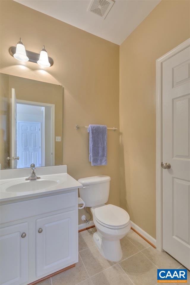 735 Rainier Road Charlottesville, VA 22903 - Photo 9 of 30 a bathroom with a toilet a sink and mirror