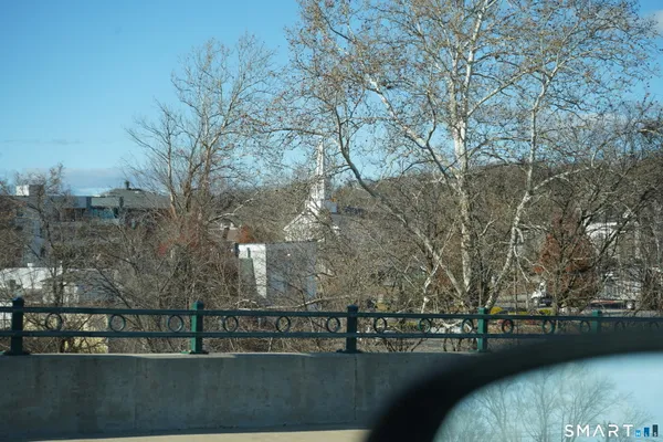a view of river and trees in the background