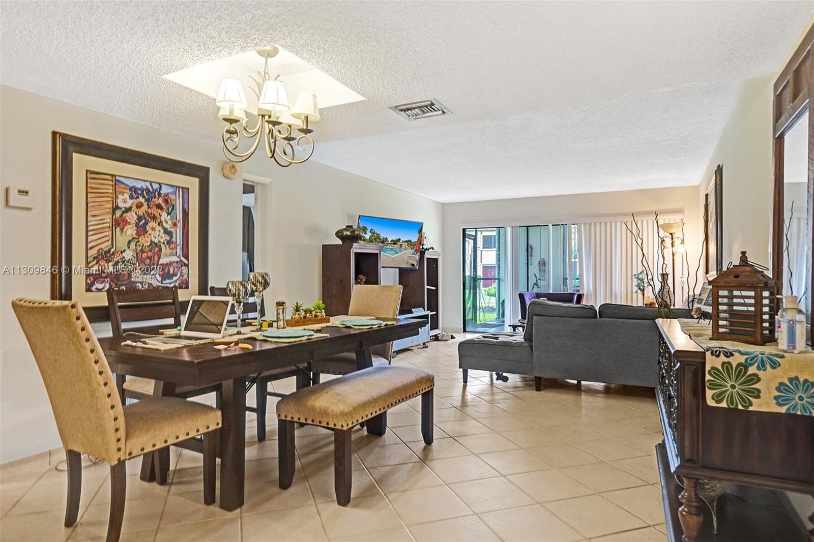 491 Racquet Club Road, Unit 101 Weston, FL 33326 - Photo 1 of 32 a view of a dining room with furniture and a chandelier