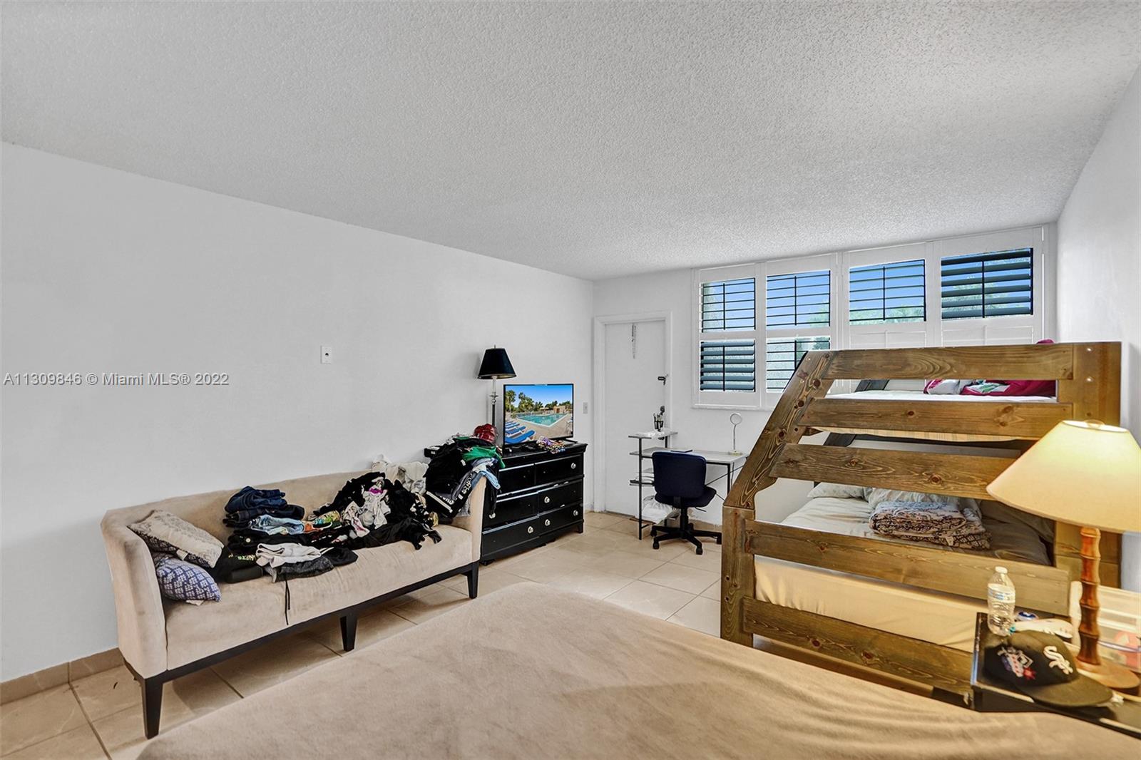 491 Racquet Club Road, Unit 101 Weston, FL 33326 - Photo 12 of 32 a bedroom with furniture and a window