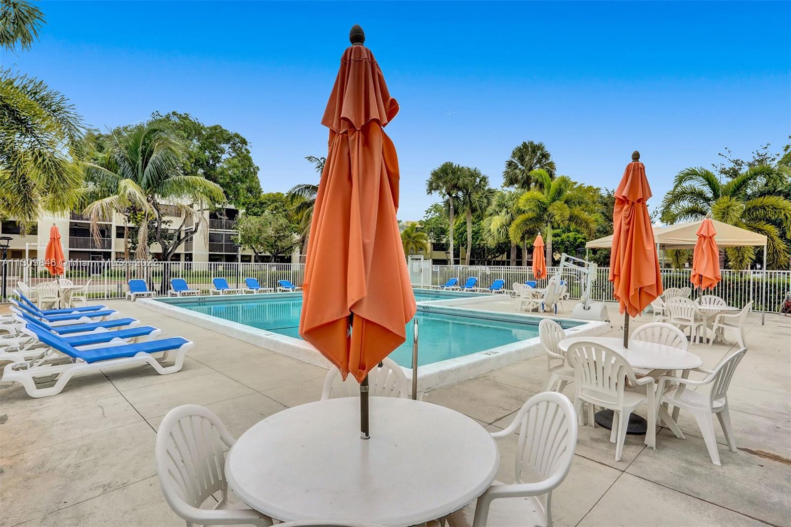 491 Racquet Club Road, Unit 101 Weston, FL 33326 - Photo 13 of 32 a view of a swimming pool with a lounge chair