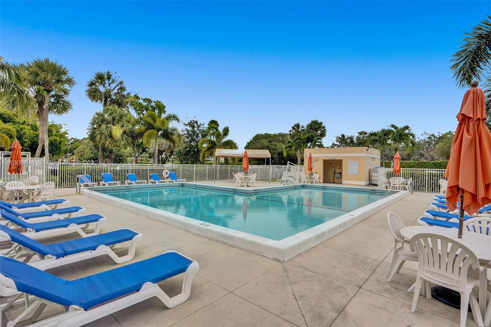 491 Racquet Club Road, Unit 101 Weston, FL 33326 - Photo 14 of 32 a view of a swimming pool with lounge chairs