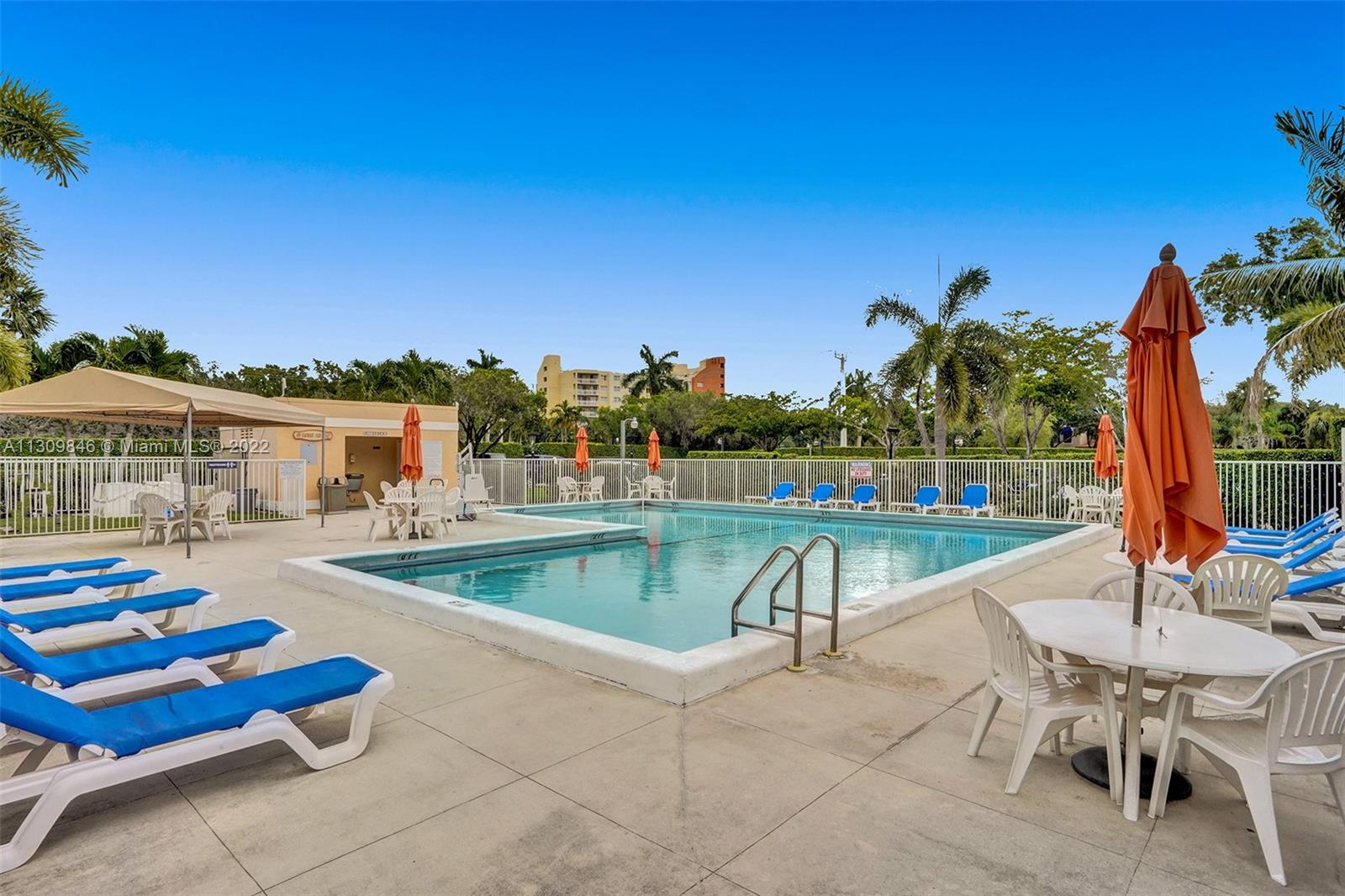 491 Racquet Club Road, Unit 101 Weston, FL 33326 - Photo 15 of 32 a view of a swimming pool with lounge chairs