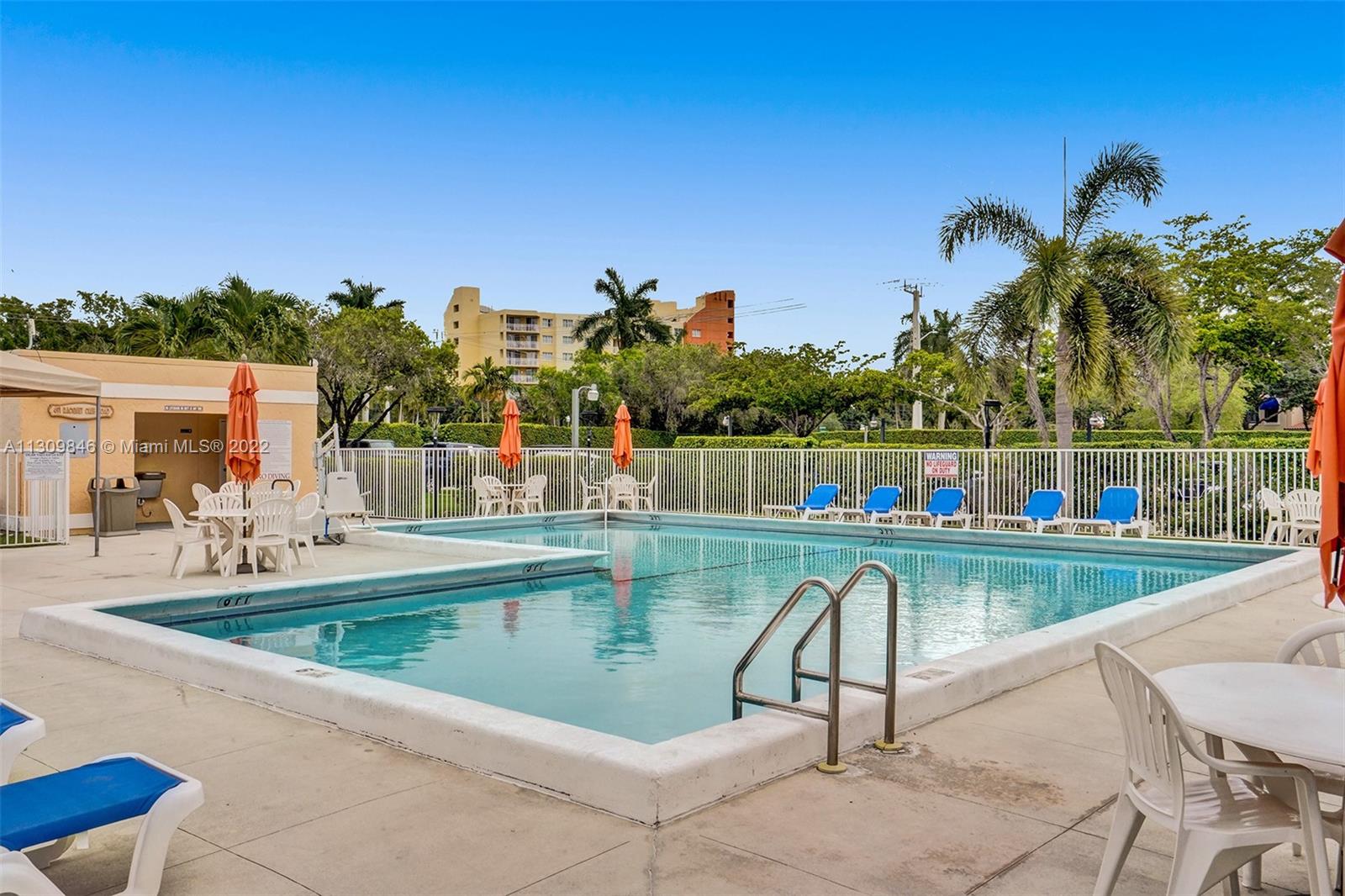 491 Racquet Club Road, Unit 101 Weston, FL 33326 - Photo 16 of 32 a view of a swimming pool with a lounge chairs