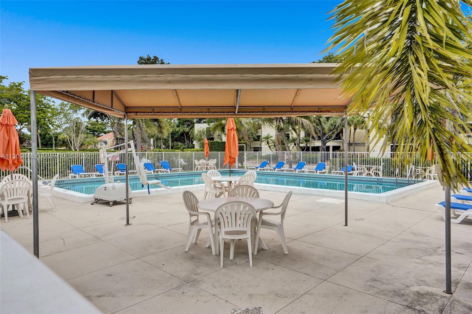 491 Racquet Club Road, Unit 101 Weston, FL 33326 - Photo 17 of 32 a view of a patio with a table and chairs