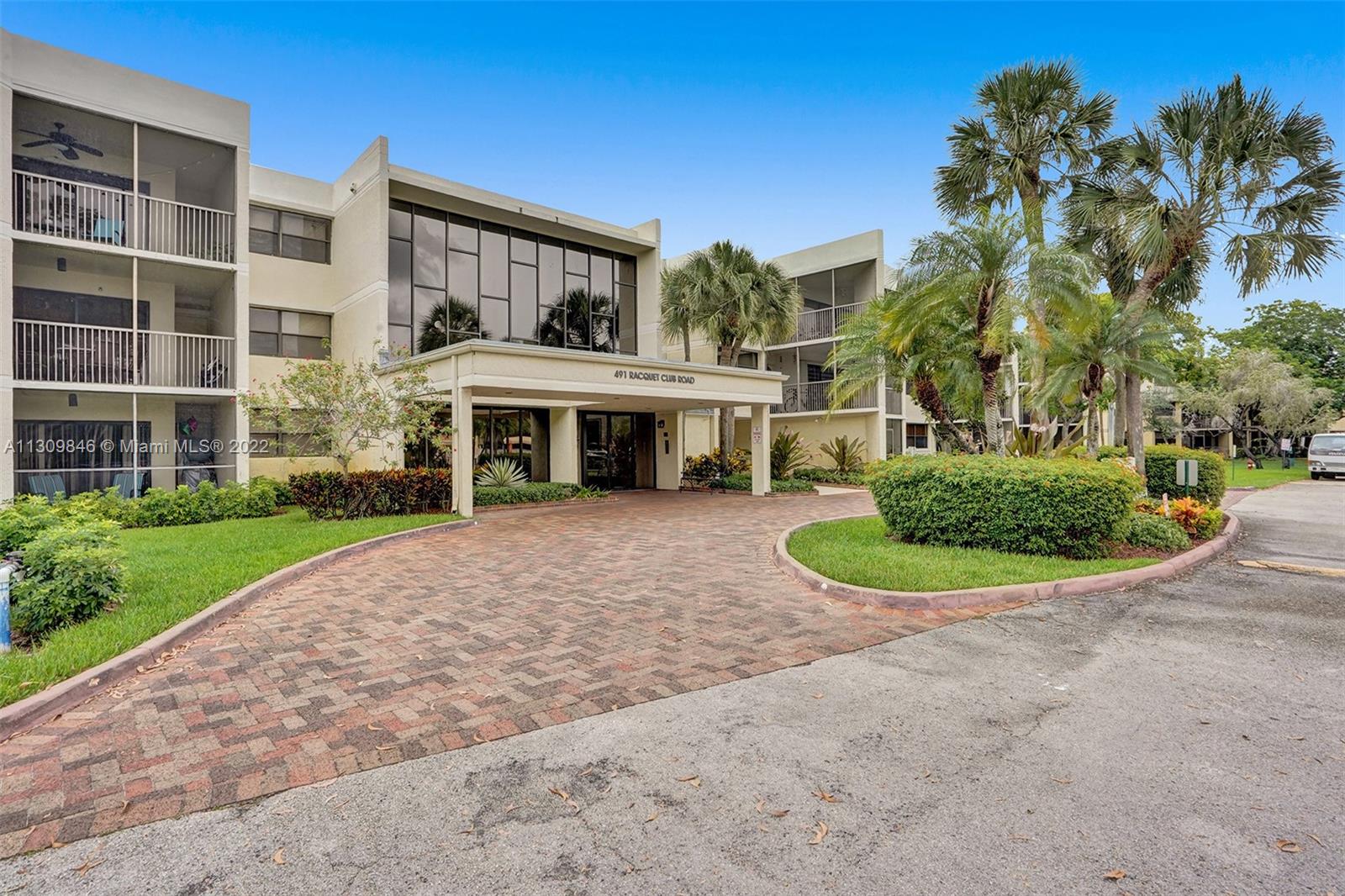 491 Racquet Club Road, Unit 101 Weston, FL 33326 - Photo 19 of 32 front view of a house with a yard