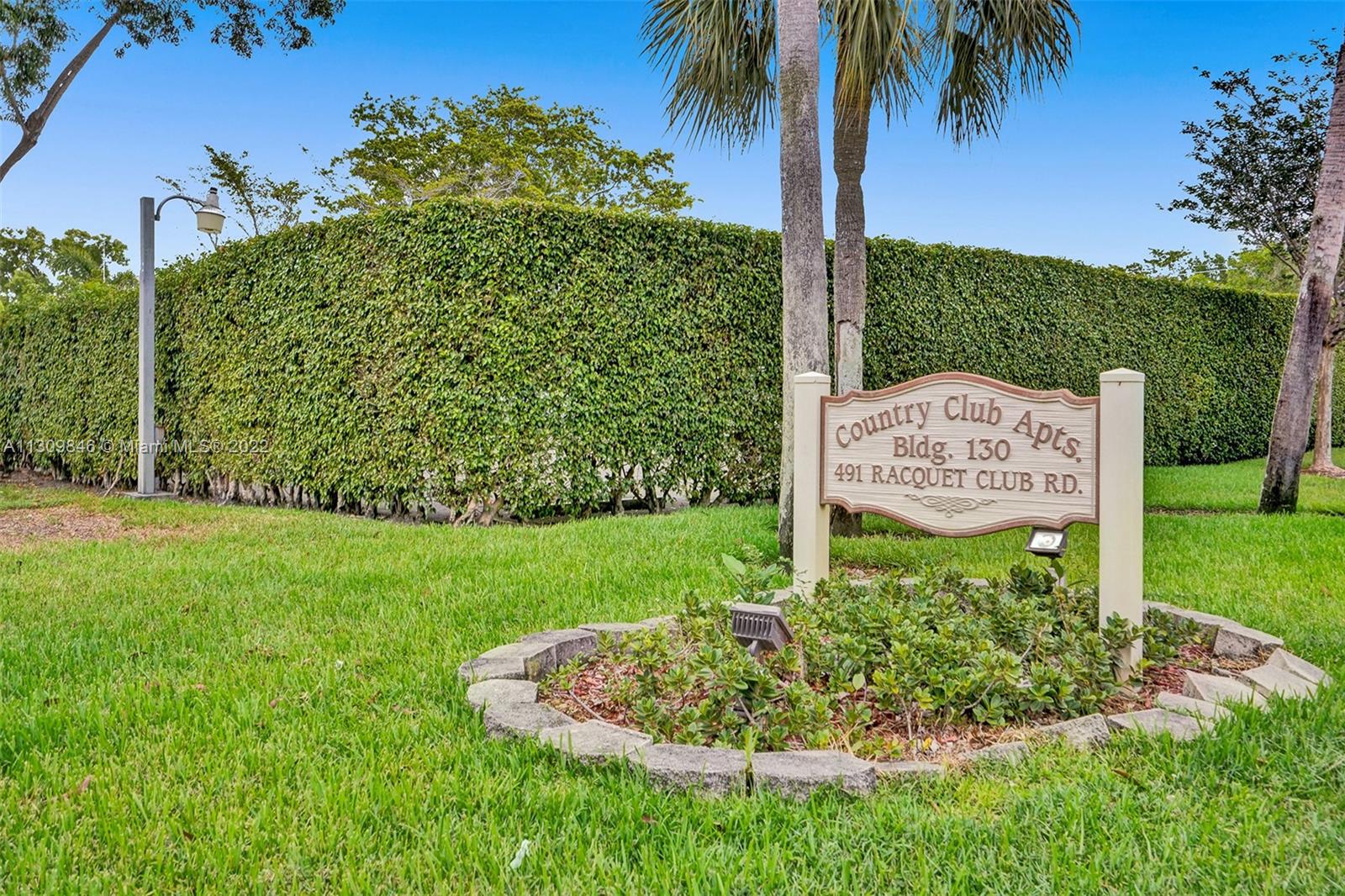 491 Racquet Club Road, Unit 101 Weston, FL 33326 - Photo 20 of 32 a sign on the side of the road