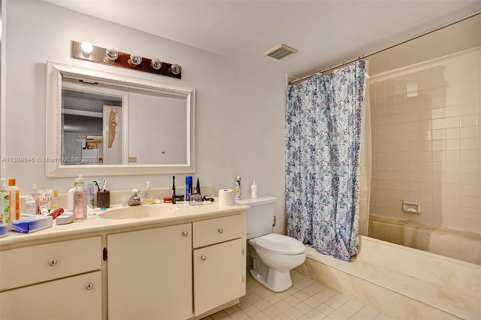 491 Racquet Club Road, Unit 101 Weston, FL 33326 - Photo 22 of 32 a bathroom with a sink toilet and shower
