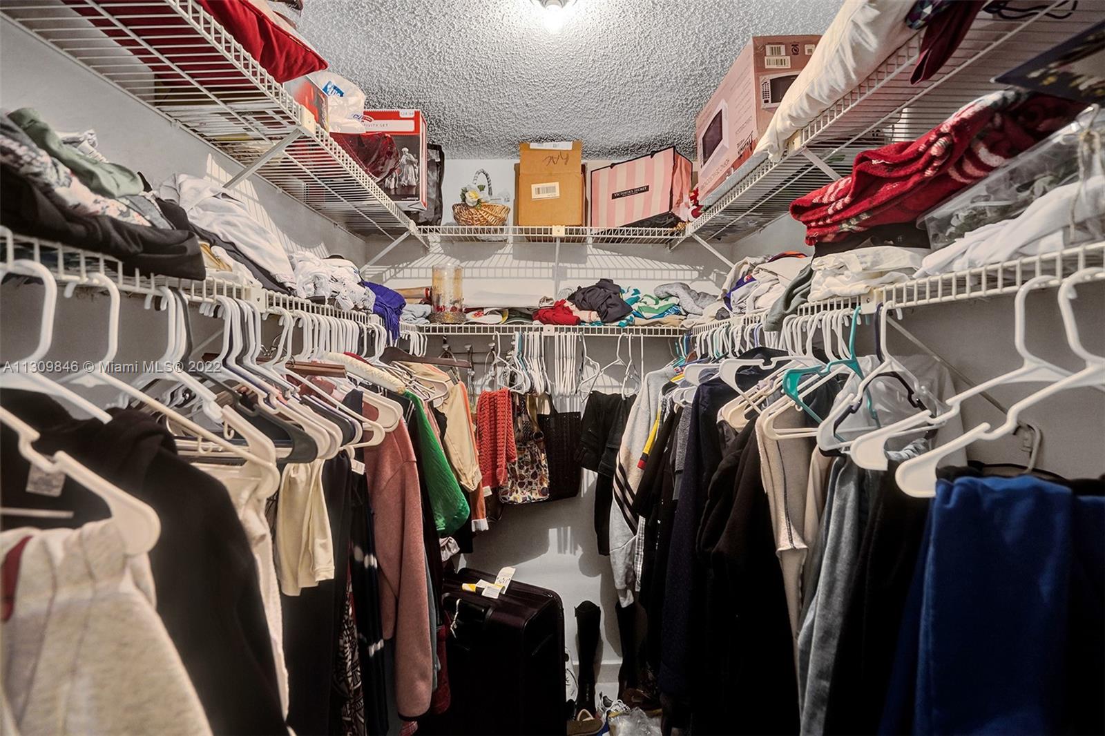 491 Racquet Club Road, Unit 101 Weston, FL 33326 - Photo 24 of 32 a view of walk in closet with clothes