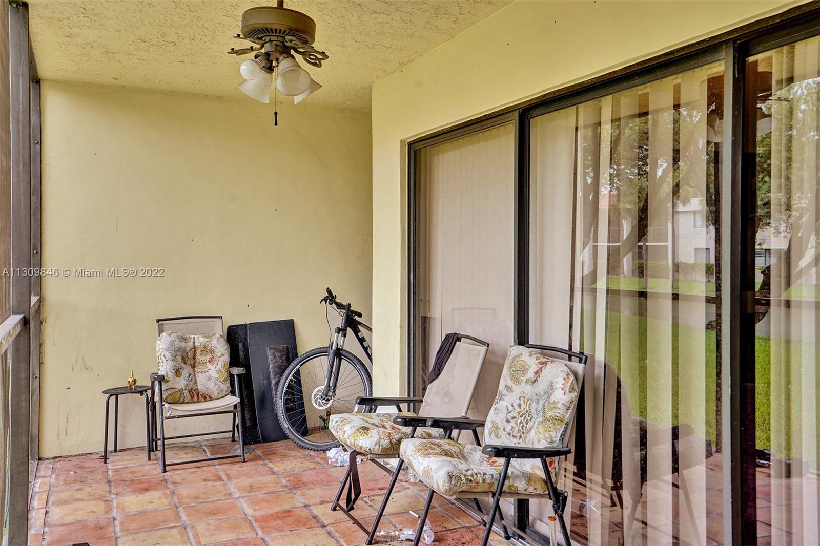 491 Racquet Club Road, Unit 101 Weston, FL 33326 - Photo 27 of 32 a view of a balcony with chairs