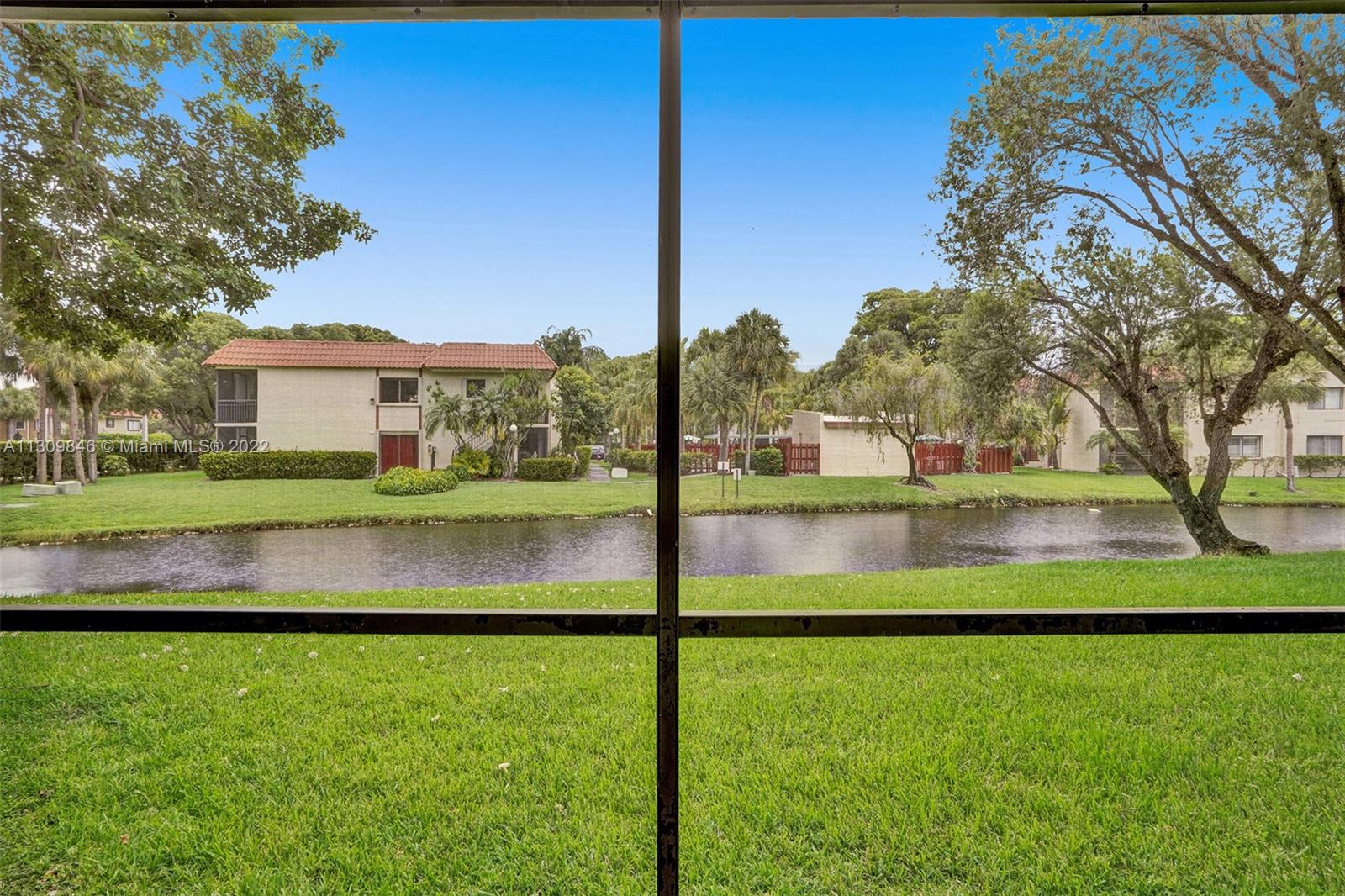 491 Racquet Club Road, Unit 101 Weston, FL 33326 - Photo 29 of 32 a view of back yard of the house with a swimming pool