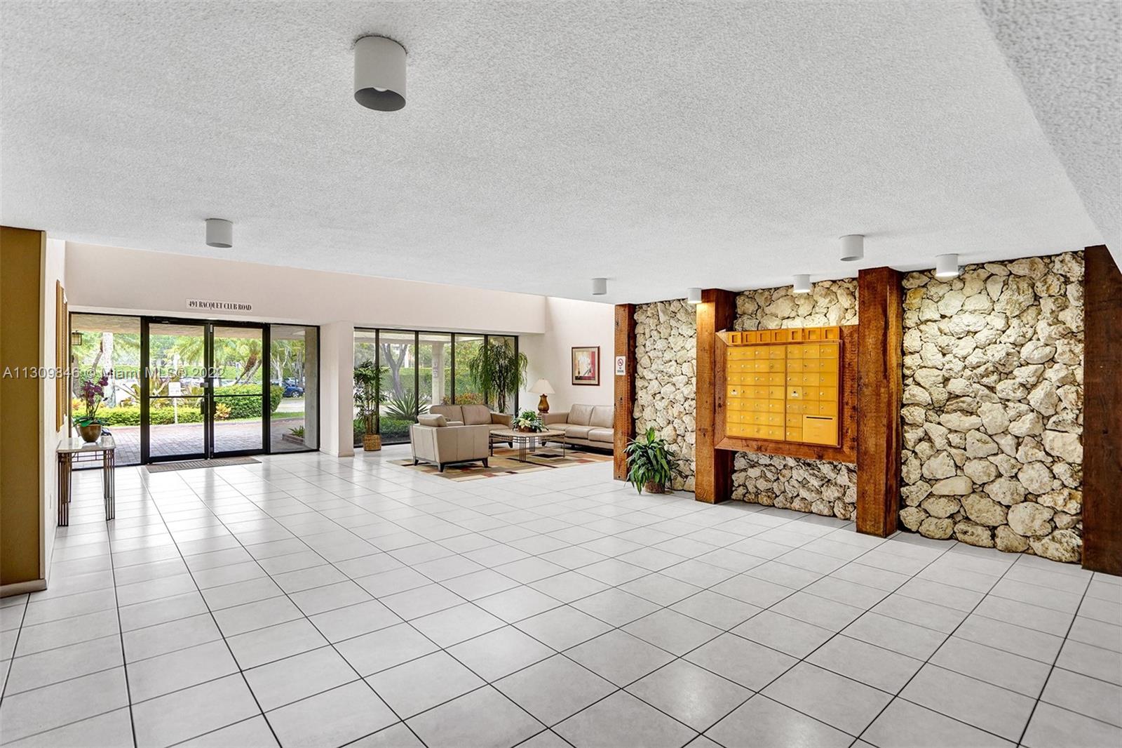 491 Racquet Club Road, Unit 101 Weston, FL 33326 - Photo 30 of 32 a spacious bedroom with a bed and a large window