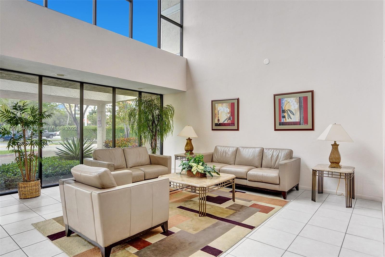 491 Racquet Club Road, Unit 101 Weston, FL 33326 - Photo 31 of 32 a living room with furniture and a large window