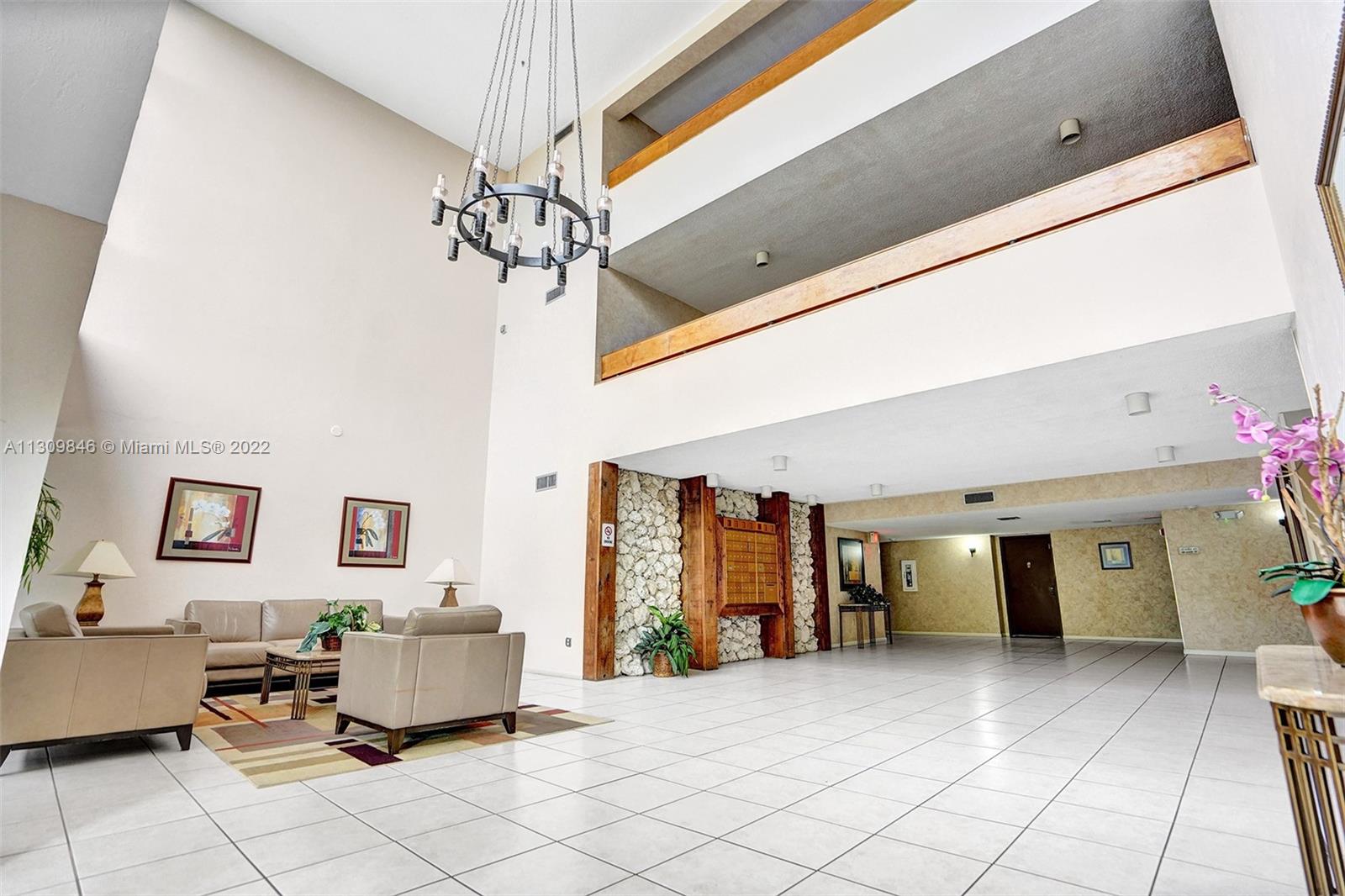 491 Racquet Club Road, Unit 101 Weston, FL 33326 - Photo 32 of 32 a living room with furniture and a chandelier
