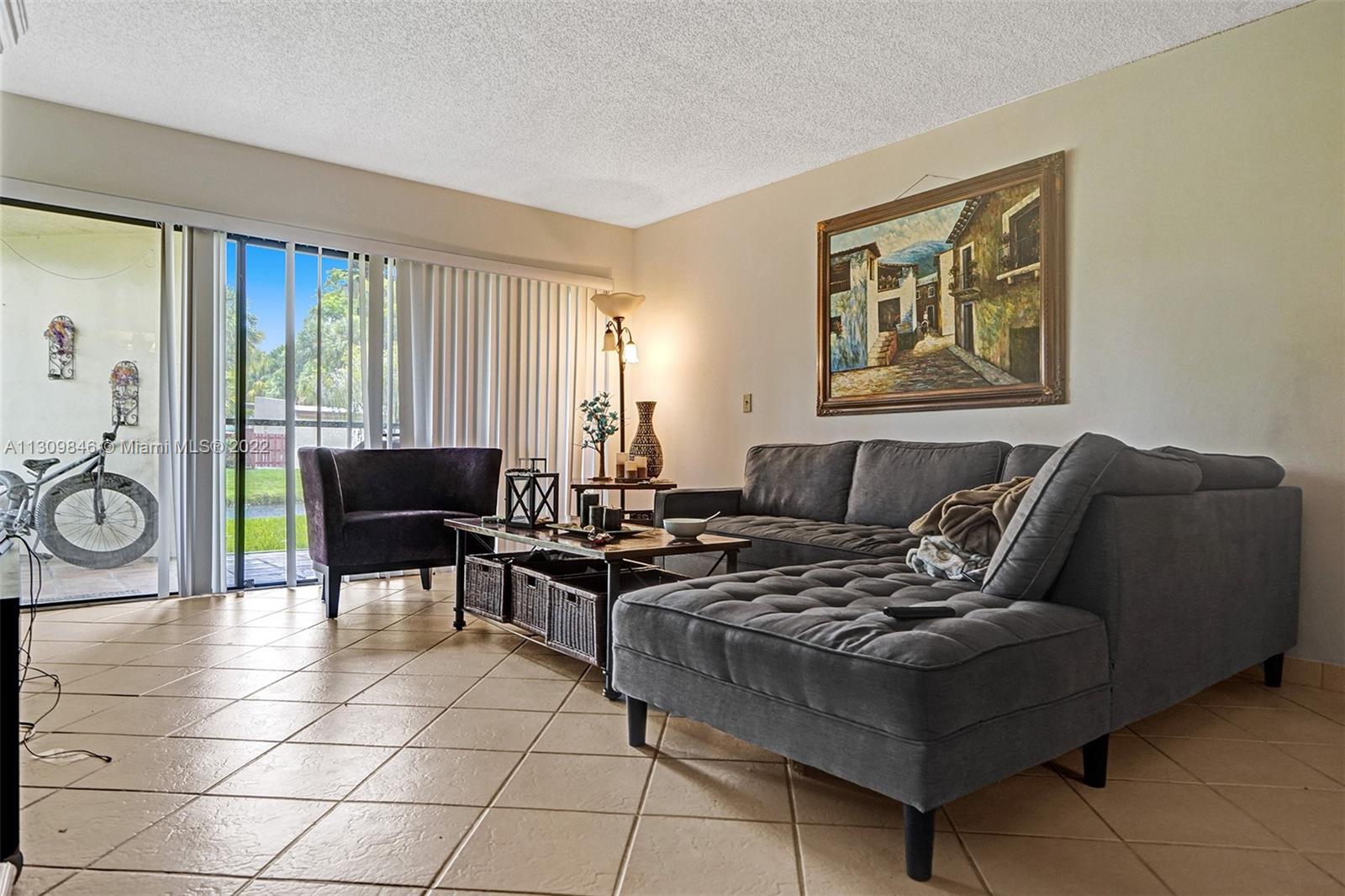 491 Racquet Club Road, Unit 101 Weston, FL 33326 - Photo 6 of 32 a living room with furniture and a window