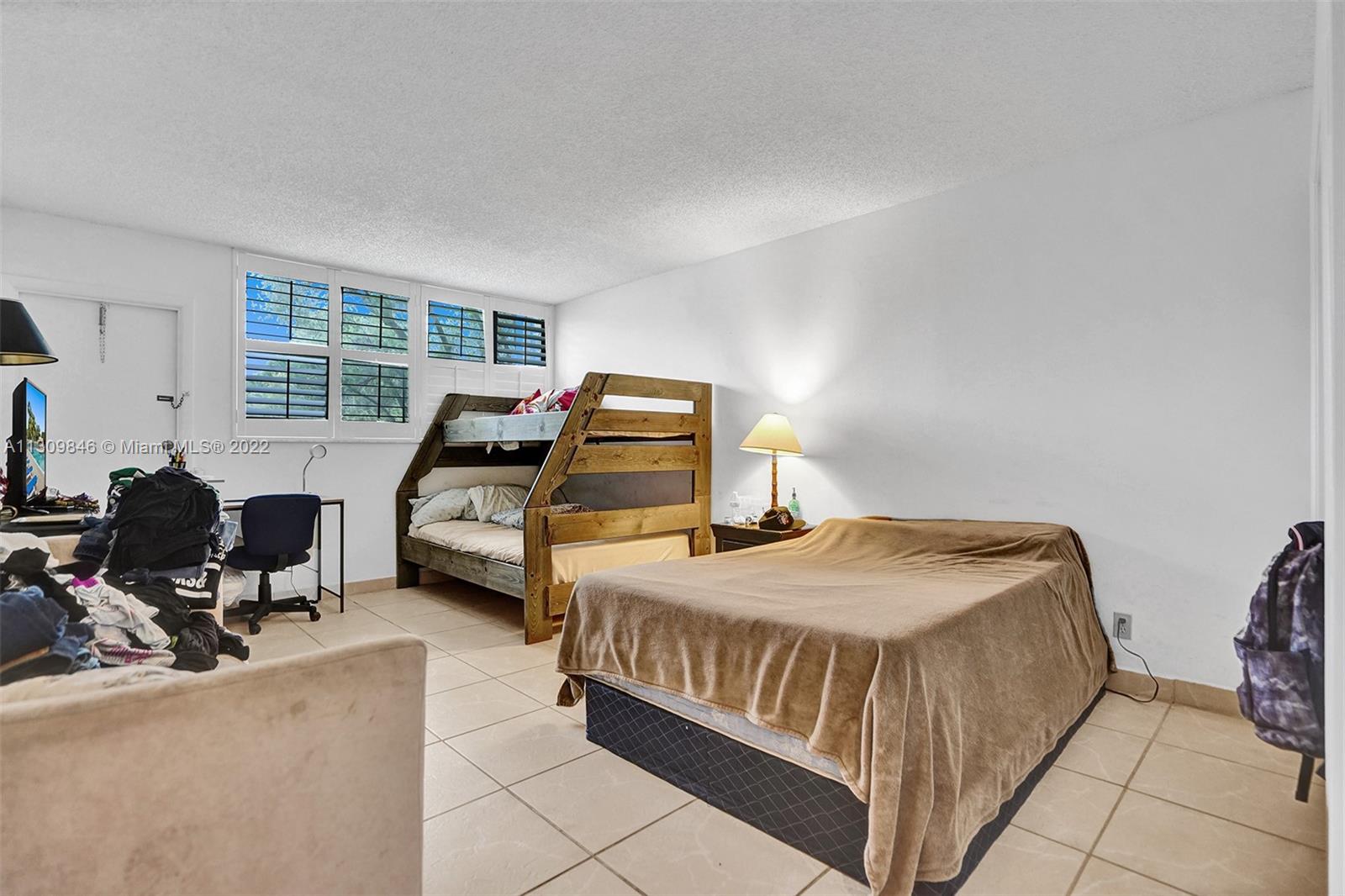 491 Racquet Club Road, Unit 101 Weston, FL 33326 - Photo 10 of 32 a bedroom with two beds and window