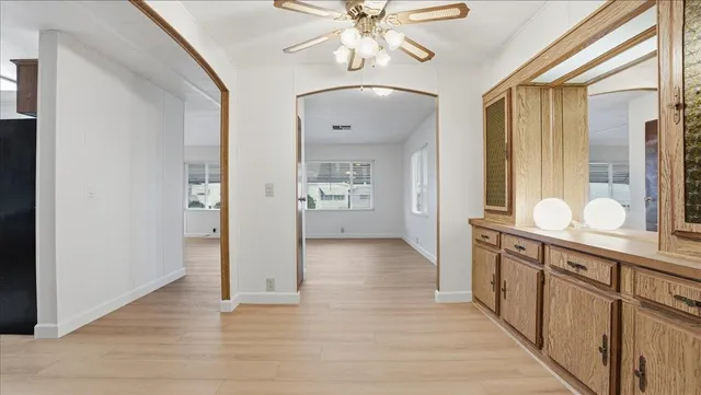 a view of a hallway with wooden floor and staircase
