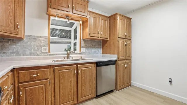 a kitchen with stainless steel appliances granite countertop a sink and a refrigerator