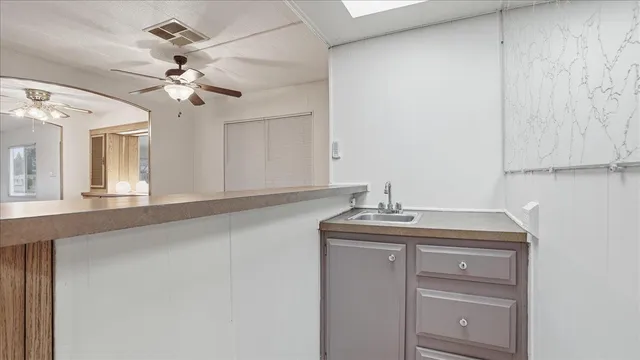 a bathroom with a granite countertop sink a mirror and vanity