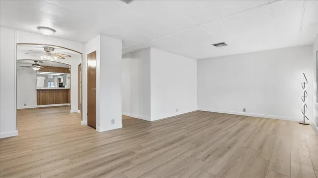 a view of a room with wooden floor and a bathroom