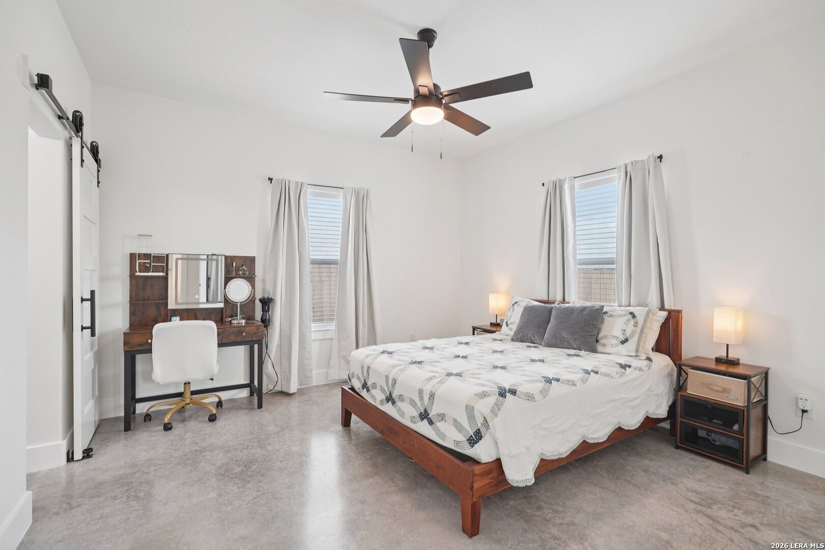 218 Colonial Lane La Vernia, TX 78121 - Photo 23 of 46 a bedroom with a bed and a chandelier