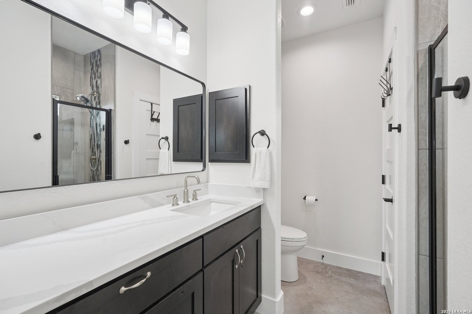 218 Colonial Lane La Vernia, TX 78121 - Photo 24 of 46 a bathroom with a double vanity sink toilet and shower