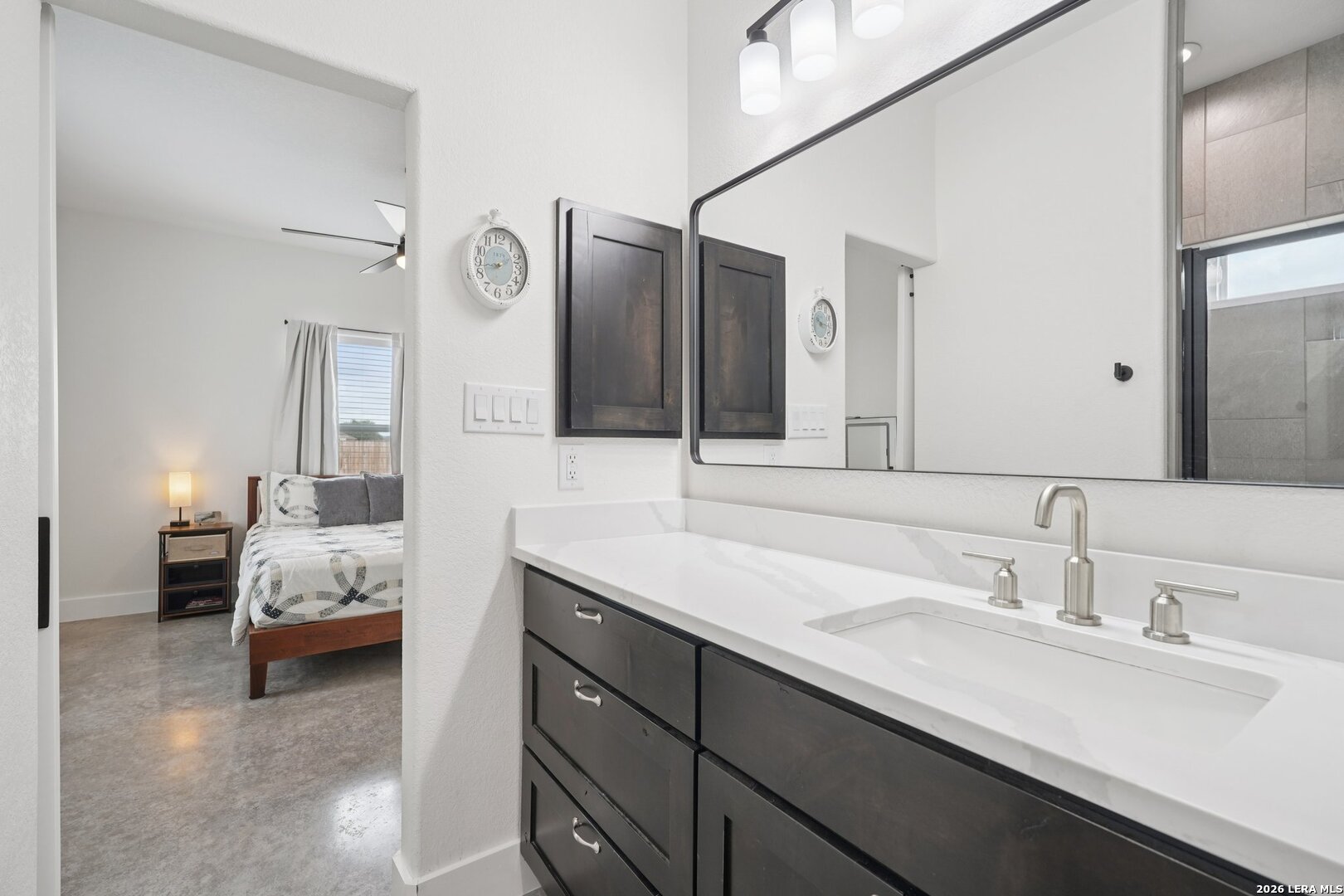 218 Colonial Lane La Vernia, TX 78121 - Photo 25 of 46 a en suite bathroom with a double vanity sink and mirror