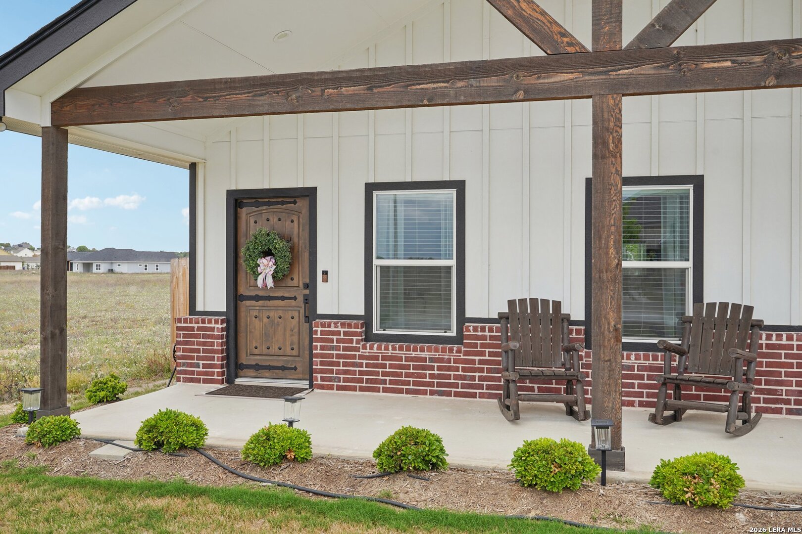 218 Colonial Lane La Vernia, TX 78121 - Photo 4 of 46 a front view of a house with outdoor seating and plants