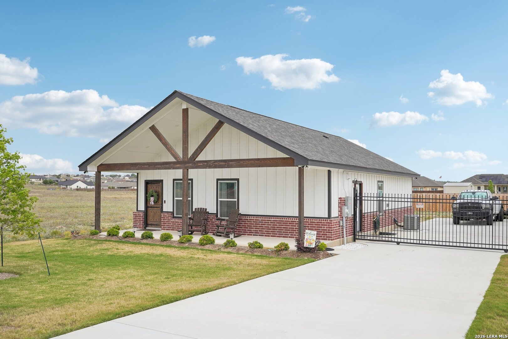218 Colonial Lane La Vernia, TX 78121 - Photo 5 of 46 a front view of a house with a yard table and chairs
