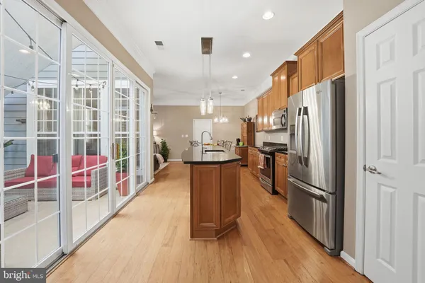 a kitchen with stainless steel appliances granite countertop a refrigerator a stove top oven and a refrigerator