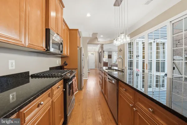 a kitchen with stainless steel appliances granite countertop a stove and a sink