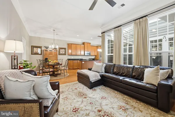 a living room with furniture wooden floor and a large window