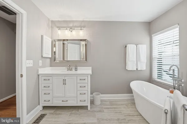 a bathroom with a bathtub and a toilet