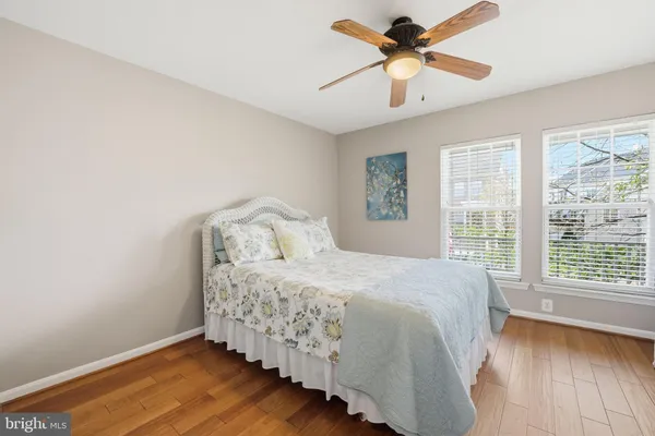 a spacious bedroom with a bed and a chandelier
