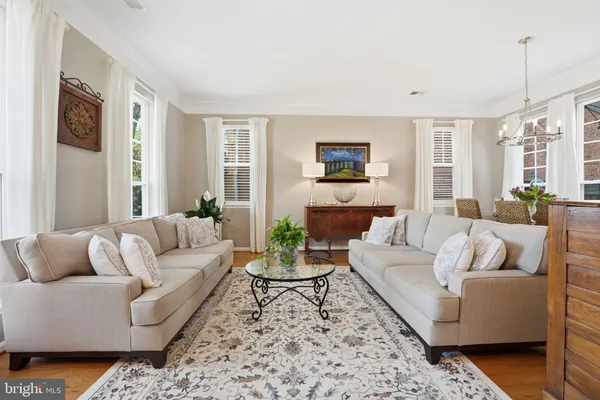 a living room with furniture fireplace and a large window